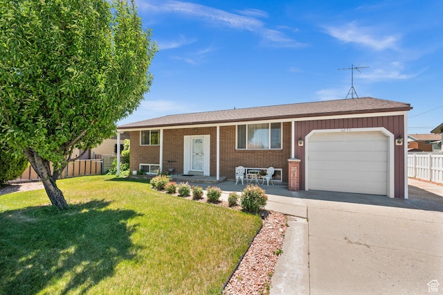 3279 W Crestfield, West Valley City, UT 84119 - raised ranch featuring an attached garage, driveway, brick siding, covered porch, and a shingled roof