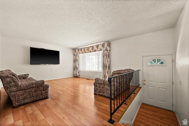 3279 W Crestfield, West Valley City, UT 84119 - entrance foyer with plenty of natural light, wood finished floors, a textured ceiling, and baseboards