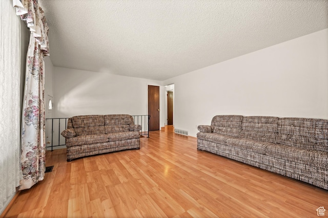3279 W Crestfield, West Valley City, UT 84119 - living area featuring wood finished floors and a textured ceiling