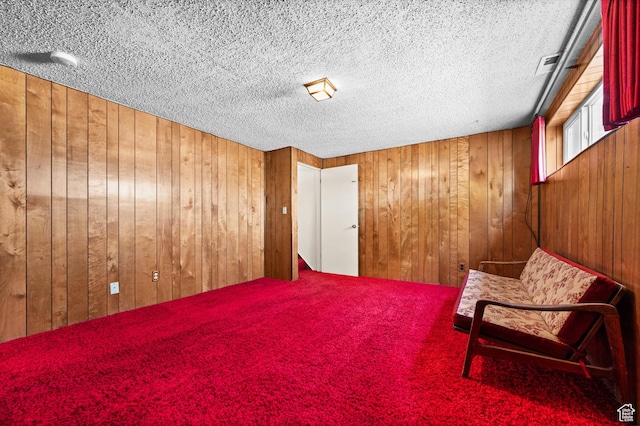 3279 W Crestfield, West Valley City, UT 84119 - living area with wood walls, carpet flooring, and a textured ceiling