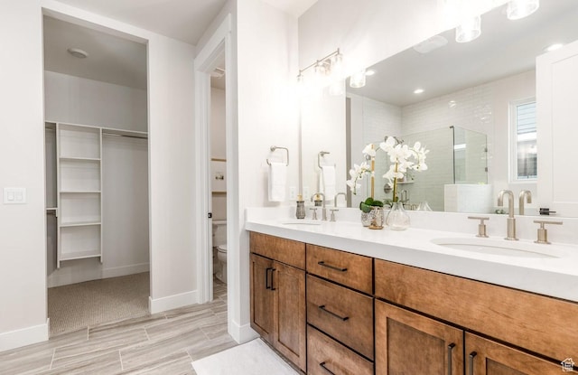11661 N Shoreline Dr, Hideout, UT 84036 - full bath with a stall shower, double vanity, toilet, a walk in closet, and baseboards