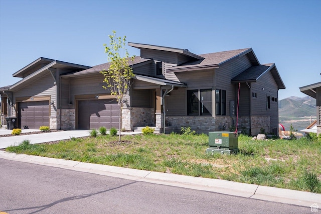 11661 N Shoreline Dr, Hideout, UT 84036 - view of front facade featuring an attached garage, stone siding, and driveway