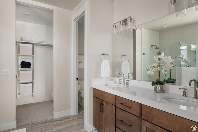11661 N Shoreline Dr, Hideout, UT 84036 - bathroom with toilet, a stall shower, double vanity, a walk in closet, and wood tiled floors