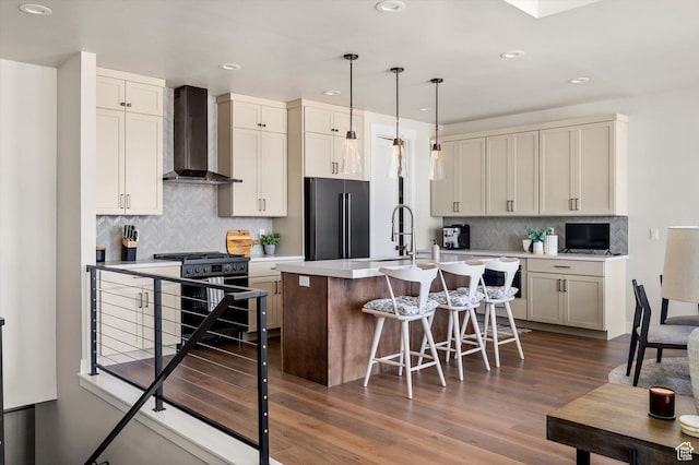 11661 N Shoreline Dr, Hideout, UT 84036 - kitchen with wall chimney range hood, high quality fridge, gas range, recessed lighting, and a kitchen island with sink