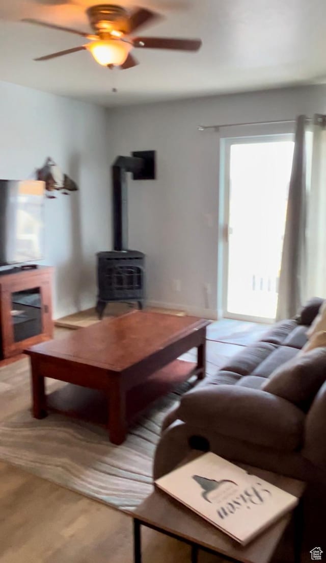 595 S Main St Unit 26, Kamas, UT 84036 - living area featuring a wood stove, a ceiling fan, and carpet