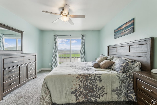 595 S Main St Unit 26, Kamas, UT 84036 - bedroom with light colored carpet, access to outside, a ceiling fan, and baseboards
