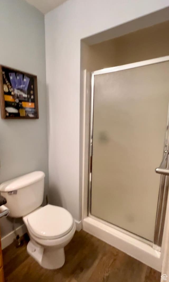595 S Main St Unit 26, Kamas, UT 84036 - bathroom featuring toilet, a stall shower, wood finished floors, and baseboards