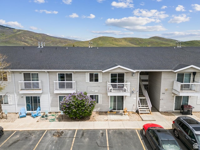 595 S Main St Unit 26, Kamas, UT 84036 - view of building exterior with a mountain view, uncovered parking, and stairway