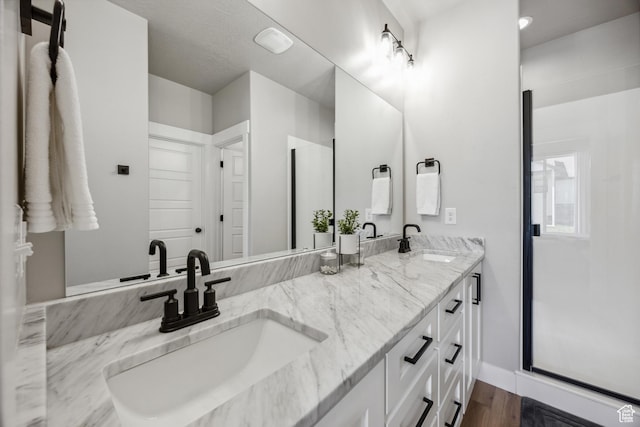 1228 N 100 E, Nephi, UT 84648 - full bathroom featuring double vanity, wood finished floors, and baseboards
