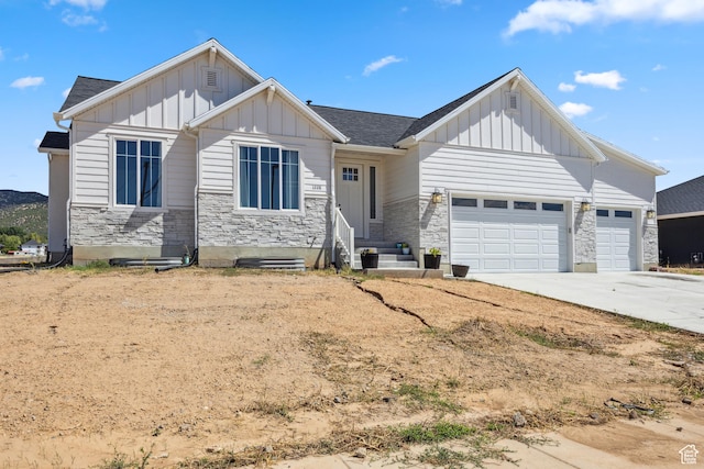 1228 N 100 E, Nephi, UT 84648 - view of front of home featuring board and batten siding, stone siding, and a garage