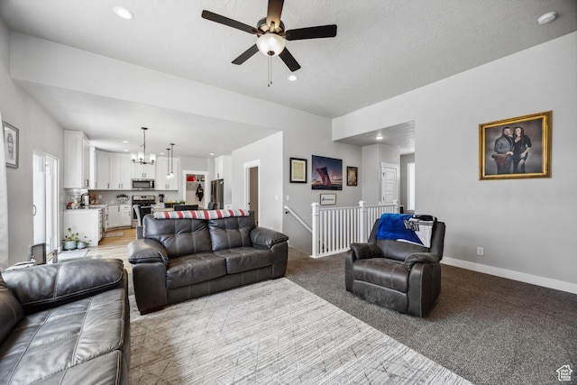 1228 N 100 E, Nephi, UT 84648 - living room featuring a chandelier, ceiling fan, recessed lighting, baseboards, and light carpet