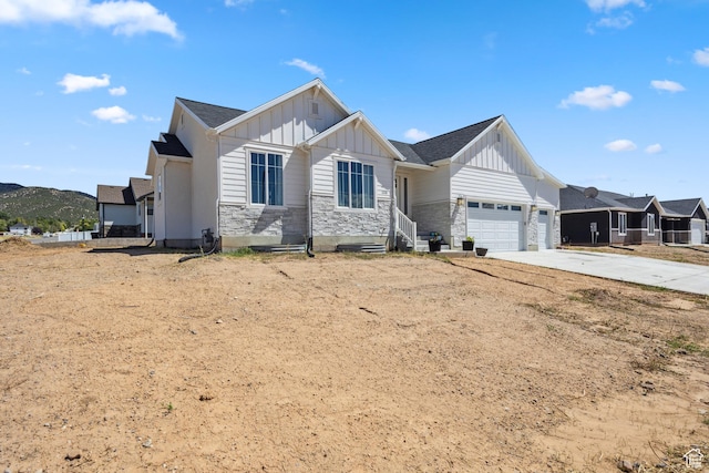 1228 N 100 E, Nephi, UT 84648 - modern farmhouse style home with board and batten siding, stone siding, a garage, and concrete driveway