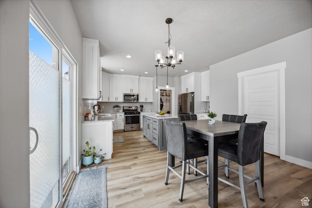 1228 N 100 E, Nephi, UT 84648 - dining area featuring a chandelier, light wood finished floors, baseboards, and recessed lighting
