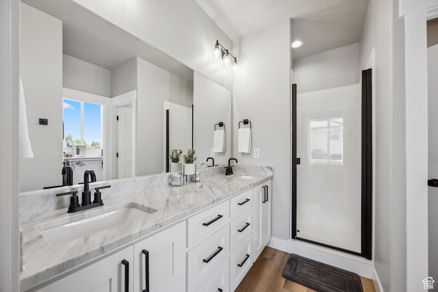 1228 N 100 E, Nephi, UT 84648 - full bathroom featuring double vanity, wood finished floors, and baseboards