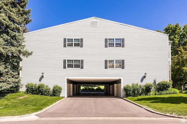 4097 S 670 E Unit C, Murray, UT 84107 - view of side of property featuring a carport, asphalt driveway, and a lawn