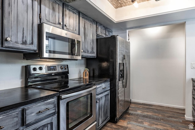 4097 S 670 E Unit C, Murray, UT 84107 - kitchen with stainless steel appliances, dark countertops, dark wood-style floors, and baseboards