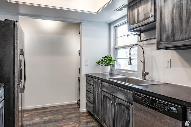 4097 S 670 E Unit C, Murray, UT 84107 - kitchen featuring appliances with stainless steel finishes, a sink, dark wood-type flooring, dark countertops, and baseboards