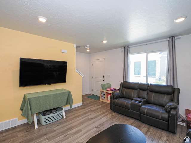 3906 S Bowie Dr W, Magna, UT 84044 - living area featuring wood finished floors, recessed lighting, and baseboards