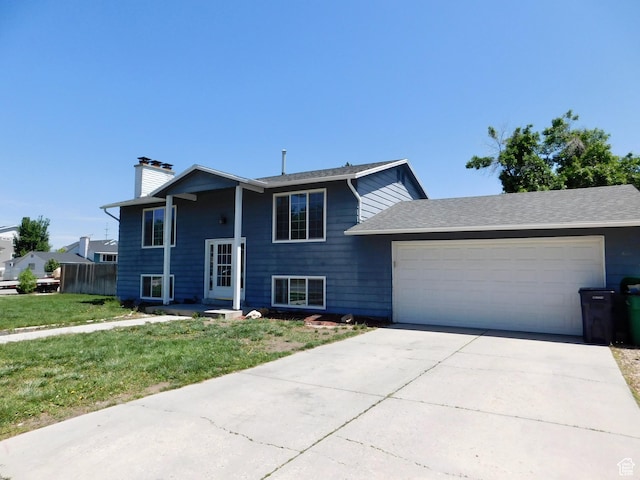 9467 S 250 E, Sandy, UT 84070 - split foyer home featuring an attached garage, a chimney, driveway, and a front lawn