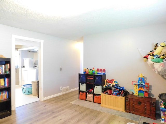 9467 S 250 E, Sandy, UT 84070 - recreation room featuring washer and dryer, light wood-style floors, and baseboards