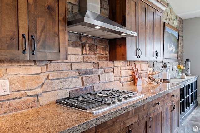 10371 N Sightline Cir, Hideout, UT 84036 - kitchen featuring wall chimney range hood, stainless steel gas stovetop, and decorative backsplash