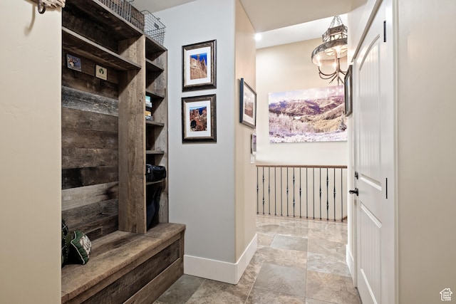 10371 N Sightline Cir, Hideout, UT 84036 - mudroom featuring baseboards, stone finish flooring, and a chandelier