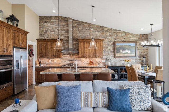10371 N Sightline Cir, Hideout, UT 84036 - kitchen with stainless steel appliances, lofted ceiling, wall chimney exhaust hood, a kitchen island with sink, and decorative backsplash