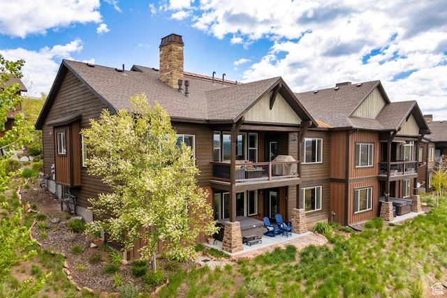10371 N Sightline Cir, Hideout, UT 84036 - rear view of property featuring a balcony, a patio area, roof with shingles, and a chimney