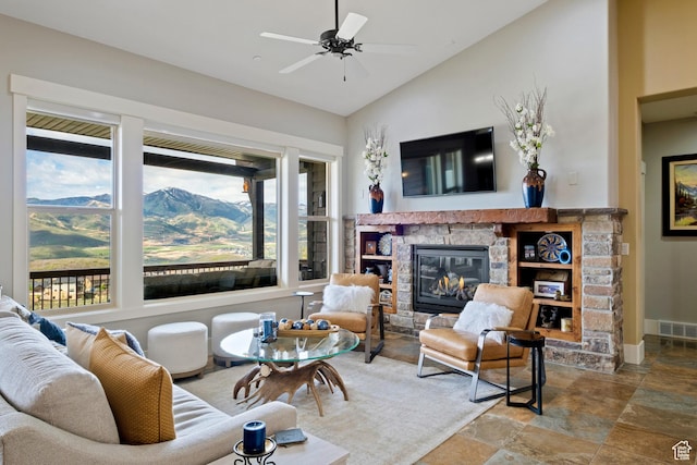 10371 N Sightline Cir, Hideout, UT 84036 - living area featuring a stone fireplace, stone finish floors, lofted ceiling, ceiling fan, and baseboards