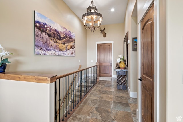 10371 N Sightline Cir, Hideout, UT 84036 - entrance foyer featuring stone finish flooring, a chandelier, baseboards, and recessed lighting