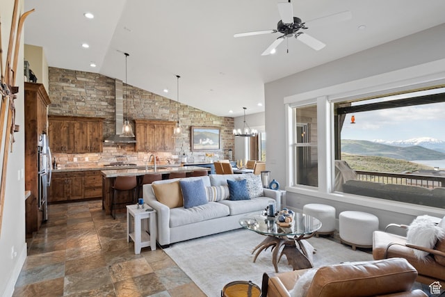 10371 N Sightline Cir, Hideout, UT 84036 - living area with dark stone finish floors, lofted ceiling, ceiling fan, recessed lighting, and a chandelier