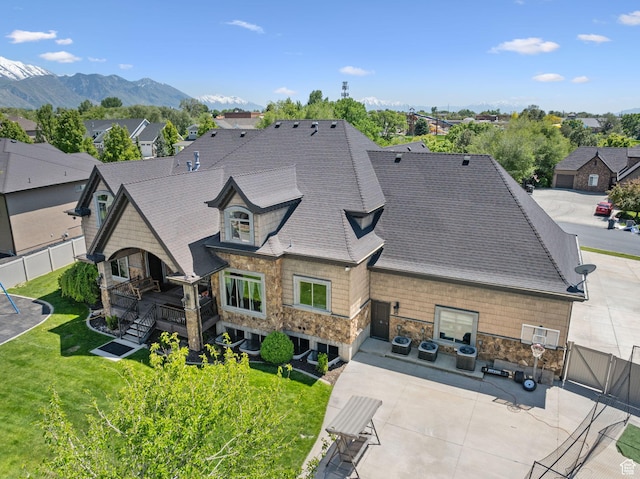62 W 225 N, Lindon, UT 84042 - back of house featuring a patio area, stone siding, a shingled roof, a residential view, and a mountain view