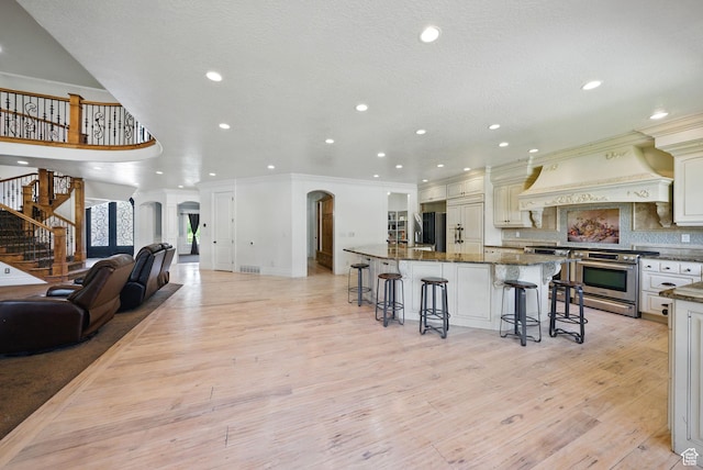 62 W 225 N, Lindon, UT 84042 - kitchen featuring appliances with stainless steel finishes, a kitchen bar, recessed lighting, light wood-style floors, and ornamental molding