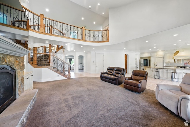 62 W 225 N, Lindon, UT 84042 - living area with recessed lighting, a towering ceiling, stairs, a fireplace, and arched walkways