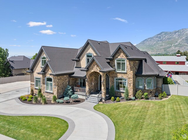62 W 225 N, Lindon, UT 84042 - view of front of home featuring stone siding, a porch, a mountain view, and curved driveway