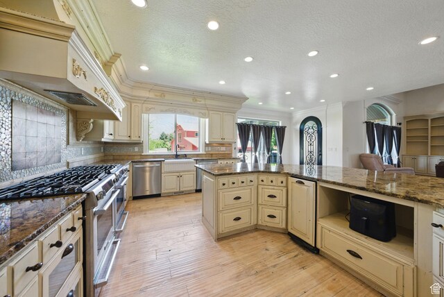 62 W 225 N, Lindon, UT 84042 - kitchen with cream cabinets, stainless steel appliances, ornamental molding, decorative backsplash, and light wood finished floors