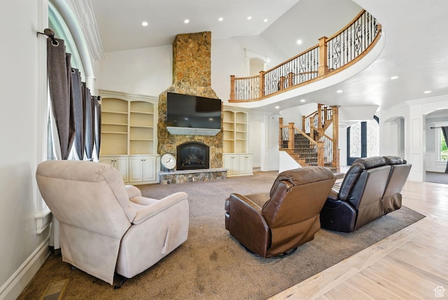 62 W 225 N, Lindon, UT 84042 - living room featuring high vaulted ceiling, a stone fireplace, baseboards, recessed lighting, and stairs