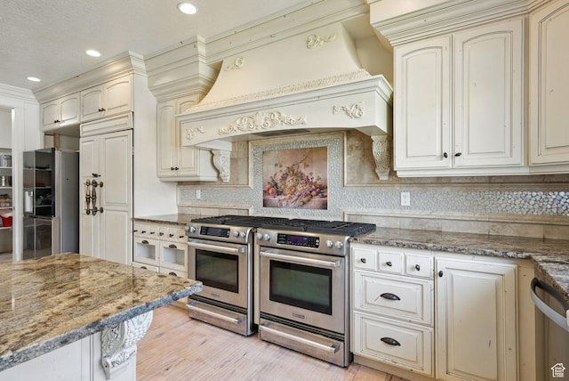 62 W 225 N, Lindon, UT 84042 - kitchen featuring stainless steel appliances, custom range hood, cream cabinets, tasteful backsplash, and stone counters