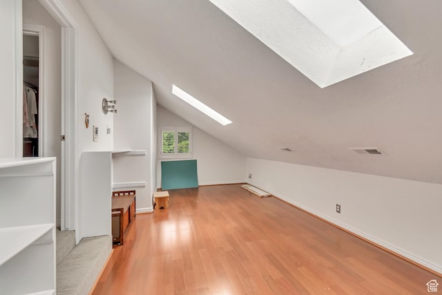 11198 S Wyngate Ln E, Sandy, UT 84092 - additional living space featuring a skylight, light wood-style floors, and vaulted ceiling