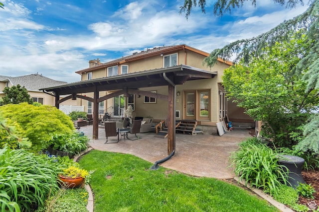 11198 S Wyngate Ln E, Sandy, UT 84092 - rear view of house featuring stucco siding, a patio area, a chimney, entry steps, and outdoor lounge area