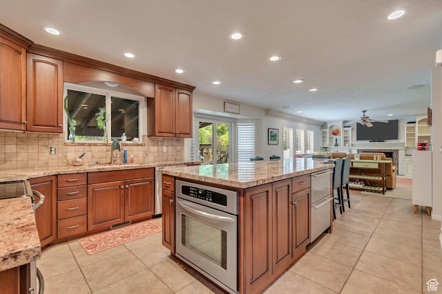 11198 S Wyngate Ln E, Sandy, UT 84092 - kitchen featuring stainless steel appliances, ceiling fan, a center island, recessed lighting, and decorative backsplash