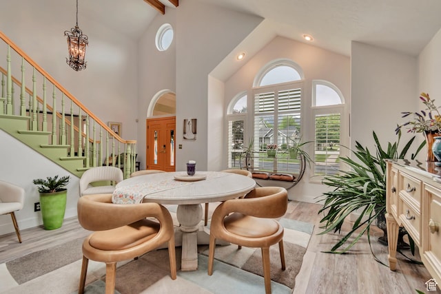 11198 S Wyngate Ln E, Sandy, UT 84092 - dining room featuring light wood-style floors, high vaulted ceiling, stairway, beam ceiling, and a chandelier