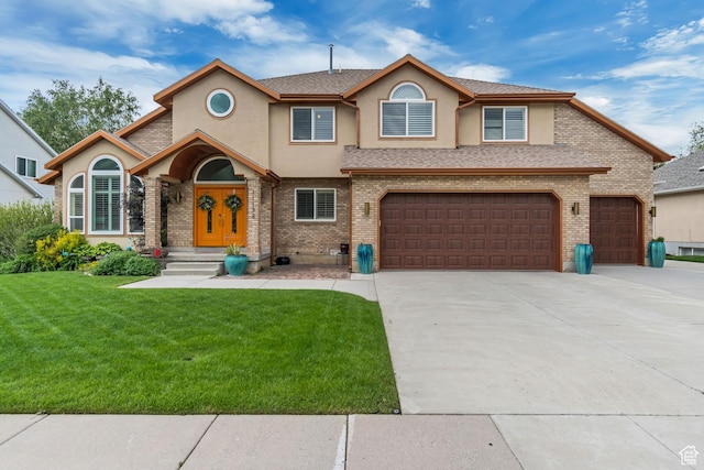 11198 S Wyngate Ln E, Sandy, UT 84092 - view of front facade with stucco siding, driveway, a front lawn, a garage, and brick siding