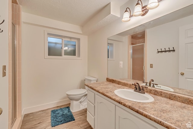 11198 S Wyngate Ln E, Sandy, UT 84092 - bathroom featuring wood finished floors, vanity, toilet, a stall shower, and a textured ceiling