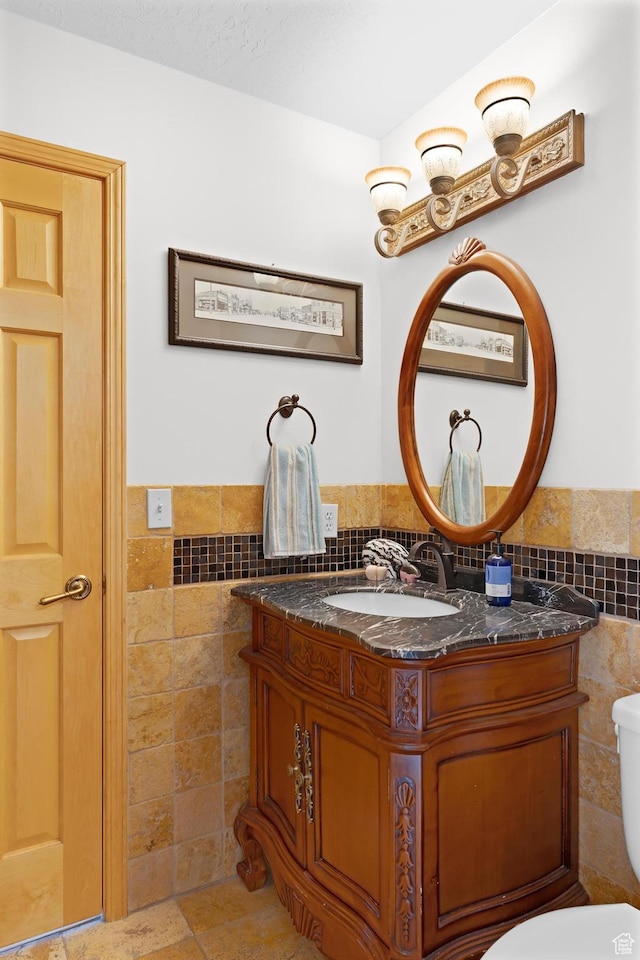 7340 Buckboard Dr N, Park City, UT 84098 - half bath with tile walls, vanity, a wainscoted wall, and toilet