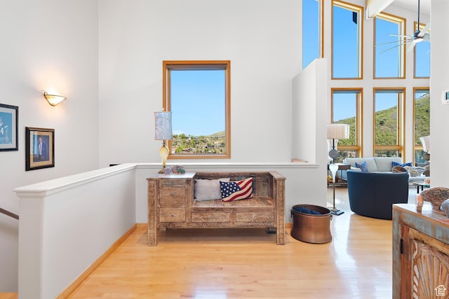 7340 Buckboard Dr N, Park City, UT 84098 - living area featuring wood finished floors, a towering ceiling, an upstairs landing, and baseboards