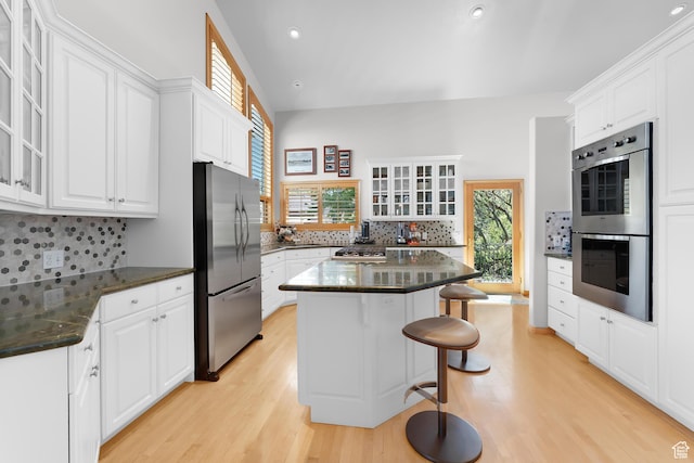 7340 Buckboard Dr N, Park City, UT 84098 - kitchen featuring stainless steel appliances, light wood-style flooring, a kitchen bar, white cabinetry, and recessed lighting