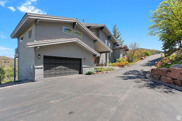 7340 Buckboard Dr N, Park City, UT 84098 - view of side of home with an attached garage and asphalt driveway