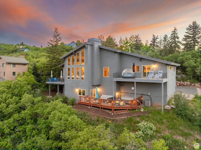 7340 Buckboard Dr N, Park City, UT 84098 - back of property with a wooden deck, a chimney, view of scattered trees, and a balcony