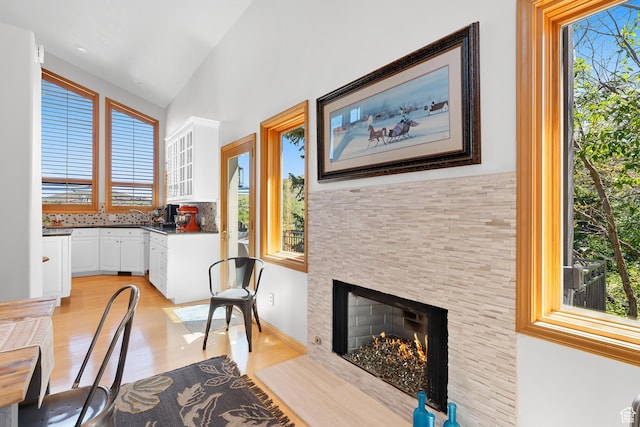 7340 Buckboard Dr N, Park City, UT 84098 - dining area featuring light wood-type flooring, a fireplace with flush hearth, and lofted ceiling